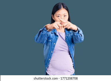 Young Beautiful Chinese Woman Pregnant Expecting Baby Rejection Expression Crossing Fingers Doing Negative Sign 