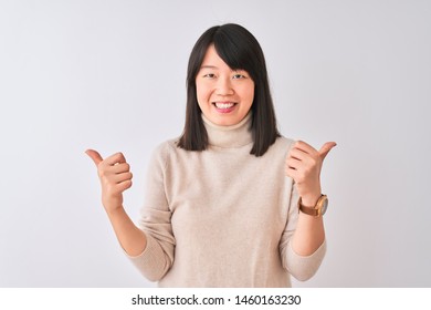 Young beautiful chinese woman wearing turtleneck sweater over isolated white background success sign doing positive gesture with hand, thumbs up smiling and happy. Cheerful expression  - Shutterstock ID 1460163230