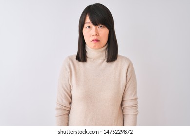 Young Beautiful Chinese Woman Wearing Turtleneck Sweater Over Isolated White Background Relaxed With Serious Expression On Face. Simple And Natural Looking At The Camera.