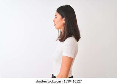 Young Beautiful Chinese Woman Wearing Casual T-shirt Standing Over Isolated White Background Looking To Side, Relax Profile Pose With Natural Face With Confident Smile.