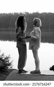 Young Beautiful Coach Helps Middle Aged Woman To Stand Barefoot On A Board With Nails. It Is Better If Someone Helps You Stand Up, Holding Hands. Board With Nails.