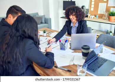 Young Beautiful Couple Applying For Mortgage. Sitting Smiling Happy Meeting With Real State Agent Signing Mortgage Loan At Bank