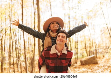 A Young Beautiful Couple In The Autumn Garden At Fall.