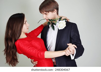 Young Beautiful Couple Dancing Tango With A Rose