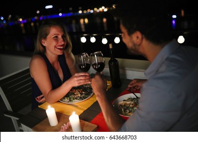 Young beautiful couple having romantic dinner on rooftop - Powered by Shutterstock