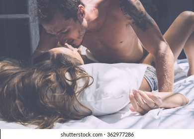 Young Beautiful Couple Kissing . Tanned Woman And A Man With A Tattoo .
