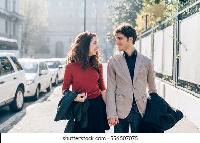 Young beautiful couple in love chatting walking outdoor in the city, having fun - first date,  romantic, love concept