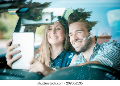 young beautiful couple lovers using tablet in the car travel - Powered by Shutterstock