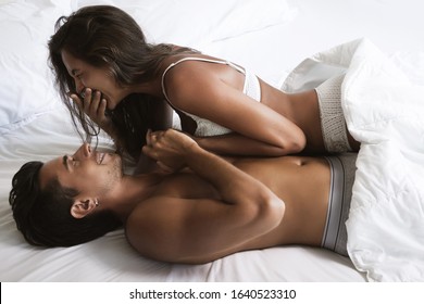 Young And Beautiful Couple Is Lying In The Bed At Morning