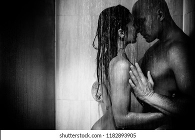 Young beautiful couple makes love in shower in monochrome