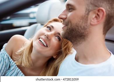 Young Beautiful Couple Smiling, Sitting In Car Near Sea.