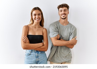 Young beautiful couple standing together over isolated background happy face smiling with crossed arms looking at the camera. positive person.  - Powered by Shutterstock