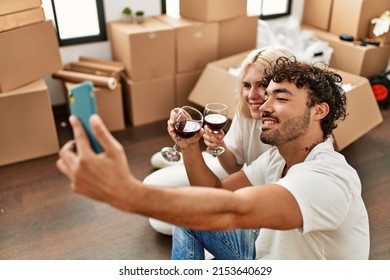 Young Beautiful Couple Toasting With Red Wine And Making Selfie At New Home