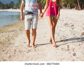 Young Beautiful Couple Walking On Tropical Beach In Thailand, Holding Hands, Hipster Outfit, Casual Style, Honey Moon, Vacation, Summertime, Sunny, Legs Close-up, Details, Bare Foot