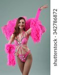 young and beautiful dancer posing on studio background