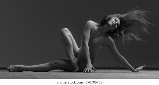 Young beautiful dancer posing in studio