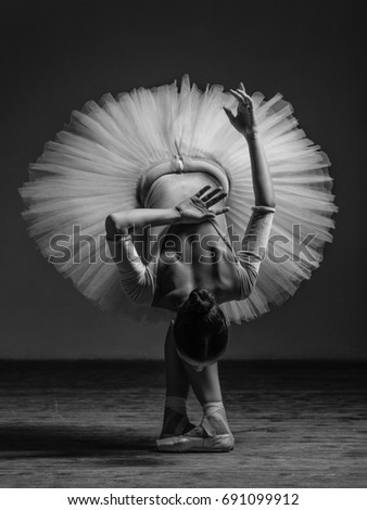 Young beautiful dancer is posing in studio