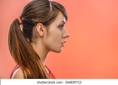 Young Beautiful Dark-haired Calm Woman In Profile, On Red Background