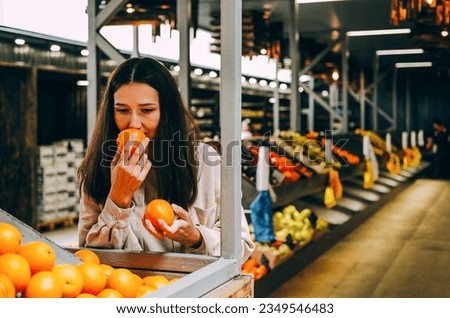Young beautiful dark-haired woman picks oranges at  local farmer's market. ストックフォト © 
