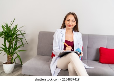 Young Beautiful Dietician Is Consulting Her Patient In Her Clinic.