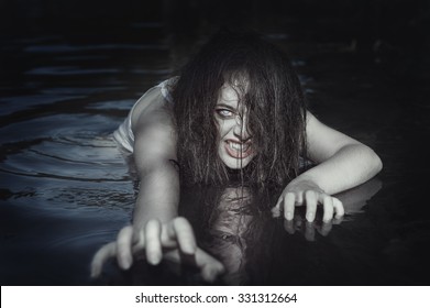 Young beautiful drowned ghost woman in the water outdoor