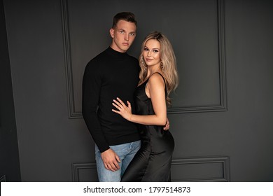 Young Beautiful Elegant Couple Posing On Black Background.