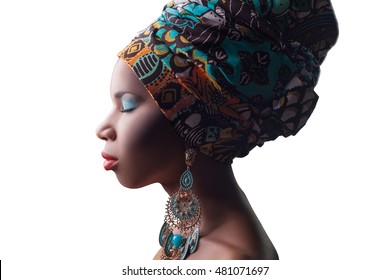 Young Beautiful Fashion Model With Traditional African Style With Scarf, Earrings And Makeup And Closed Eyes Isolated On White Background.