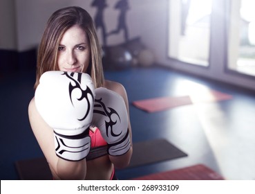 Young Beautiful Female Boxer Portrait At Gym