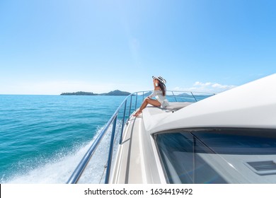 young beautiful female model lying on the deck of a yacht at sea.