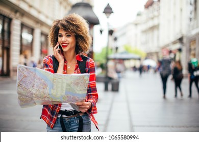 Young beautiful female traveler lost in the city
