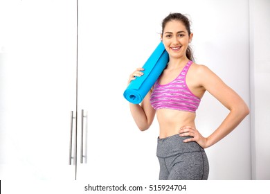 Young Beautiful Female Yoga Instructor Or Yoga Studio Owner Standing In Front Of Yoga Studio Door