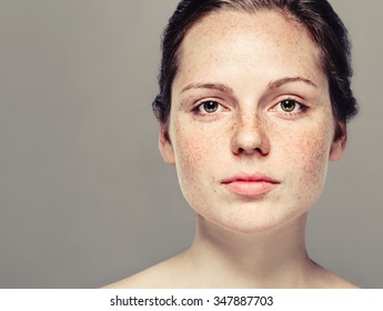 Young Beautiful Freckles Woman Face Portrait With Healthy Skin