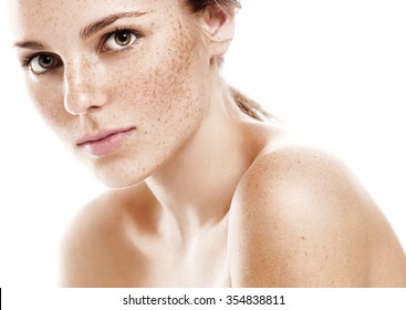 Young beautiful freckles woman face portrait with healthy skin 