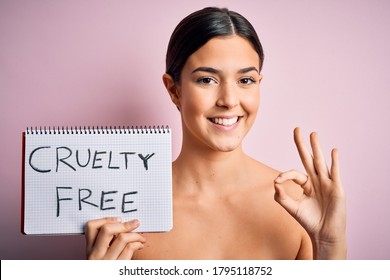 Young beautiful girl asking for cruelty free and vegan beauty cosmetics over pink background doing ok sign with fingers, excellent symbol