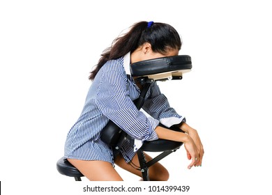 Young beautiful girl brunette office worker in a shirt and with bare legs sitting on a massage chair. The face is not visible. Business concept and massage.