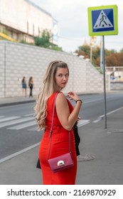 Young Beautiful Girl With Curvy Body Shape Standing On Street Background Wearing Red Close Fitting Sleeveless Dress