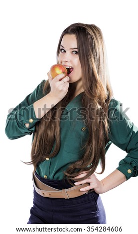Young beautiful girl with dark curly hair, holding big  apple to enjoy the taste and are dieting, healthy eating and organic foods, feeling temptation, smile, teeth.