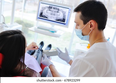 Young Beautiful Girl In Dental Glasses On Examination At The Dentist. Dental Health, Enamel, Whitening, Tooth Filling.