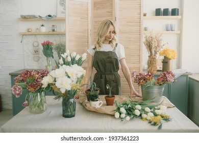 Young Beautiful Girl Florist Collects A Bouquet Of White Tulips In A Flower Shop