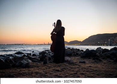 Young Beautiful Girl With Her Cello On The Outside