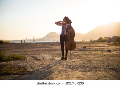 Young Beautiful Girl With Her Cello On The Outside