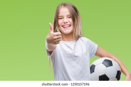 Young beautiful girl holding soccer football ball over isolated background happy with big smile doing ok sign, thumb up with fingers, excellent sign - Powered by Shutterstock