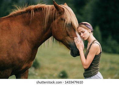 Young beautiful girl hugs horse at nature. - Powered by Shutterstock