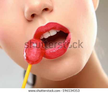Young beautiful girl with lollipop in her mouth