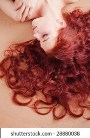Young beautiful girl with long hair lying on the floor
