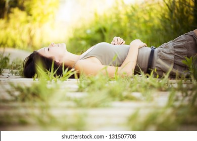 Young beautiful girl lying in nature.