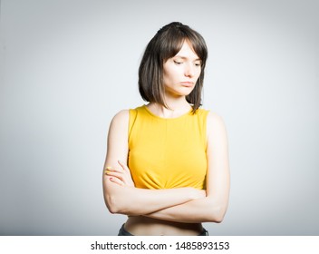 young beautiful girl offended and turned away isolated on white background