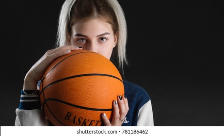 Young Beautiful Girl Posing Holding Basketball Ball Standing On Black Background