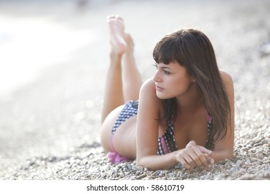 Young beautiful girl posing on the beach