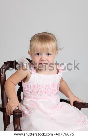 Young Beautiful Girl sitting on a chair, studio shot
